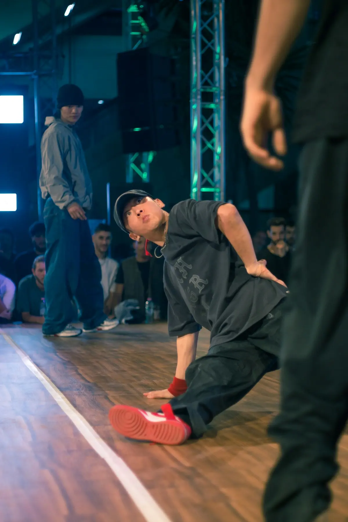A young dancer working a step on the studio's wooden floor.